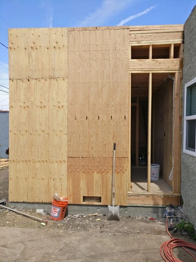 Sheathing & Openings &mdash; Window and door openings framed and sheathed.