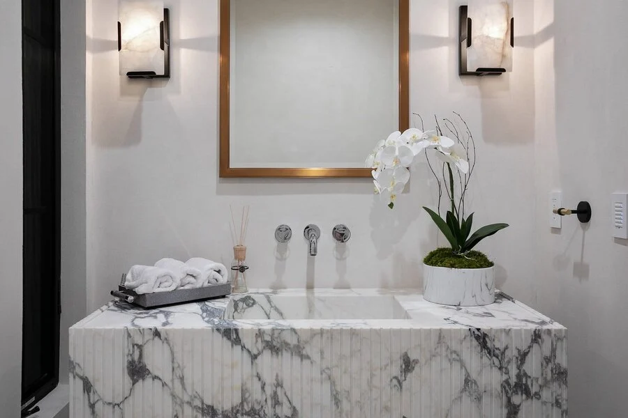 Marble Tub Deck &mdash; A soaking tub set into a full-slab marble deck.