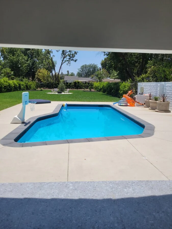 Kidney Pool &mdash; A freeform pool framed by a clean concrete deck.