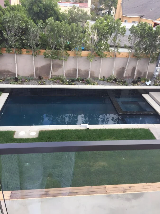 Aerial View &mdash; Two pools and a manicured lawn from above.