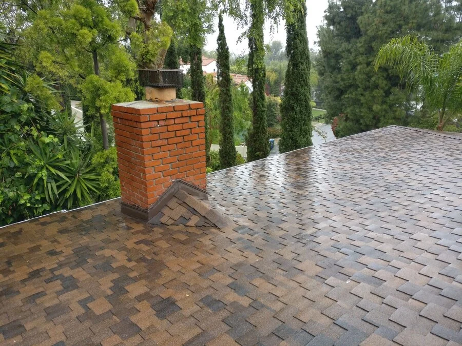 Chimney Detail &mdash; Flashing and shingle work after a fresh rain.