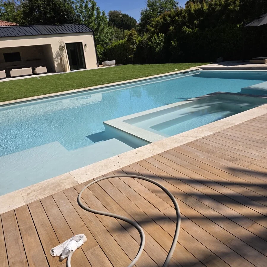 The Pool & Spa &mdash; A wood deck wraps the pool and pool house.