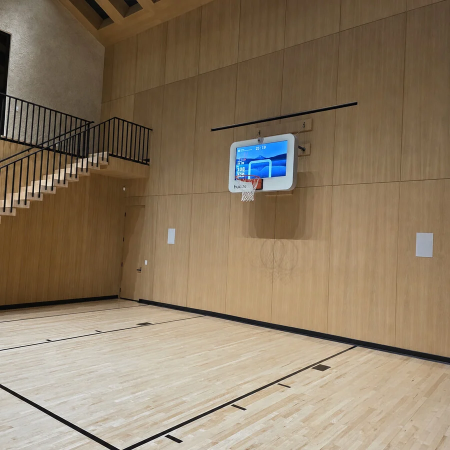 The Sport Court &mdash; An indoor court, framed in warm wood paneling.