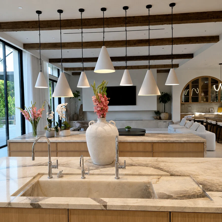 The Kitchen &mdash; Vaulted wood beams over a stone waterfall island.