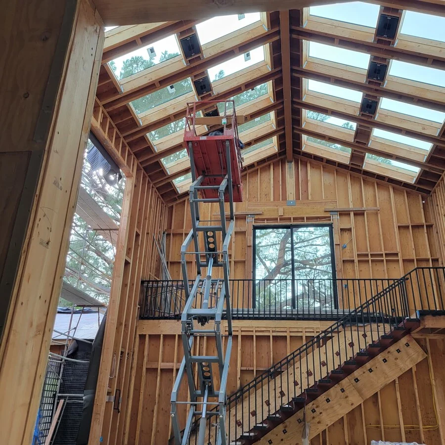 Vaulted Ceiling Frame &mdash; Exposed beams and a skylight take shape overhead.
