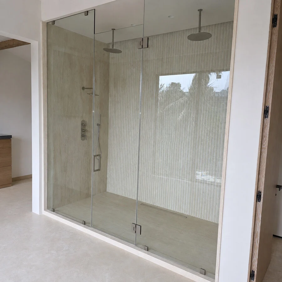 The Primary Bath &mdash; Dual rain showers behind a glass enclosure.