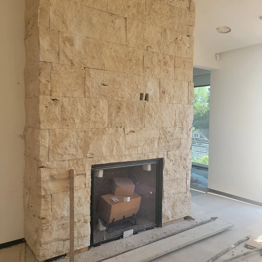 The Fireplace &mdash; Floor-to-ceiling natural stone, framing the hearth.