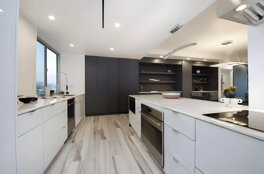 The Island &mdash; Matte cabinetry framing a marble-topped island.