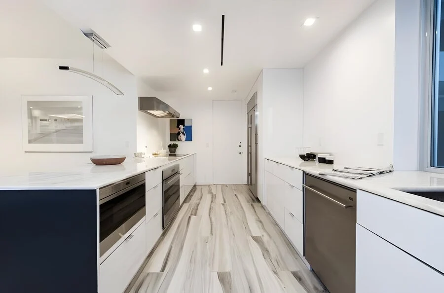 Kitchen, Straight On &mdash; Integrated appliances disappear into the millwork.