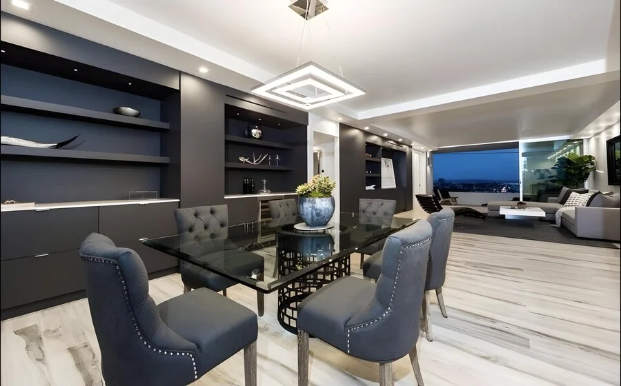 Dining Room &mdash; Tufted chairs at a glass table, skyline beyond.